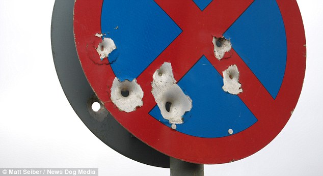 Sinister: This No Stopping sign near the A40 in Oxfordshire is riddled with what appear to be bullet-holes